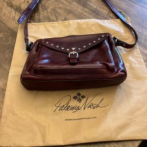 Patricia Nash cross body purse. Strap is 45 inches long and adjustable.